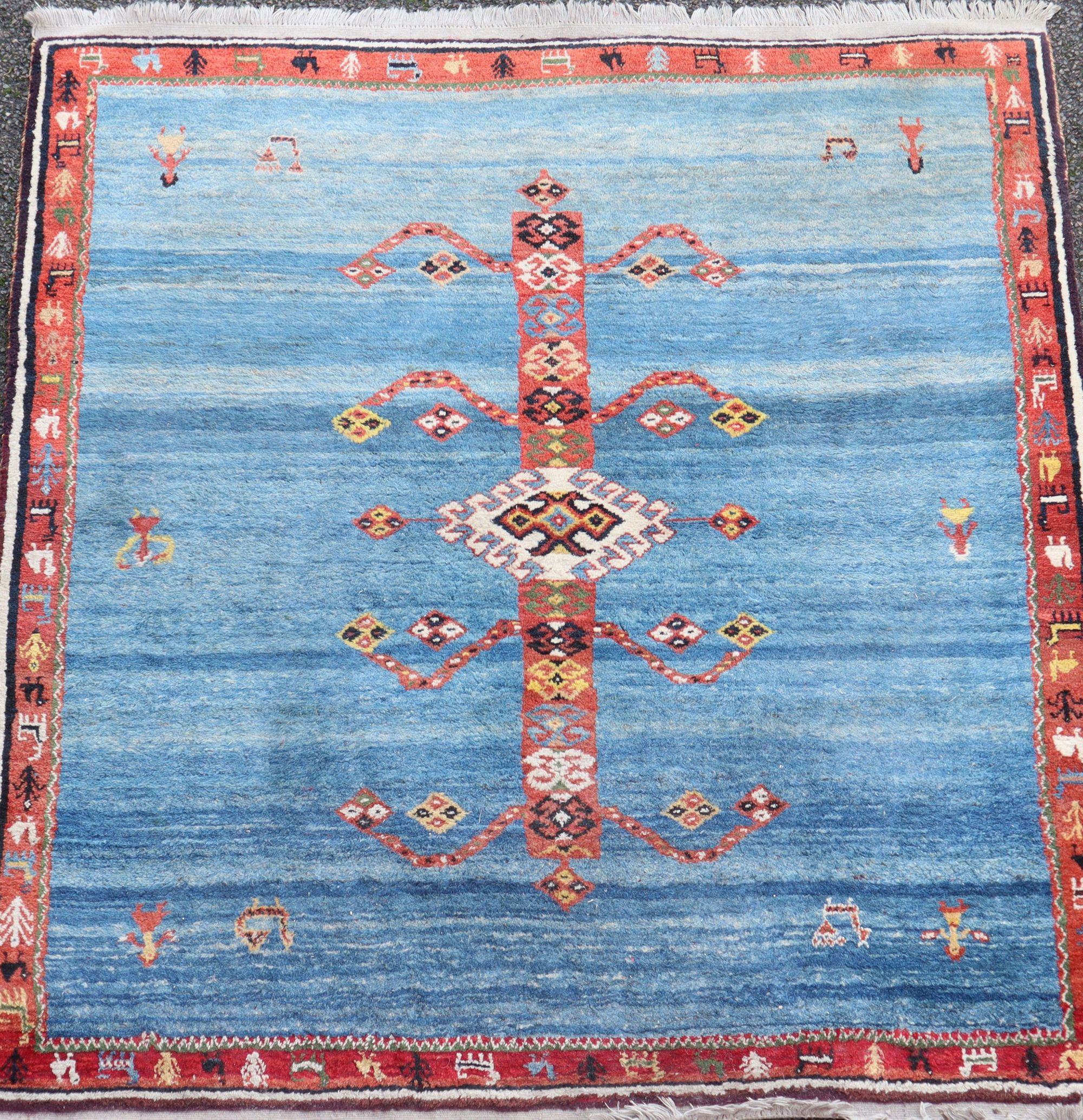 An Iranian Qushqai Gabbeh blue ground carpet, 6ft 10in by 6ft 8in.